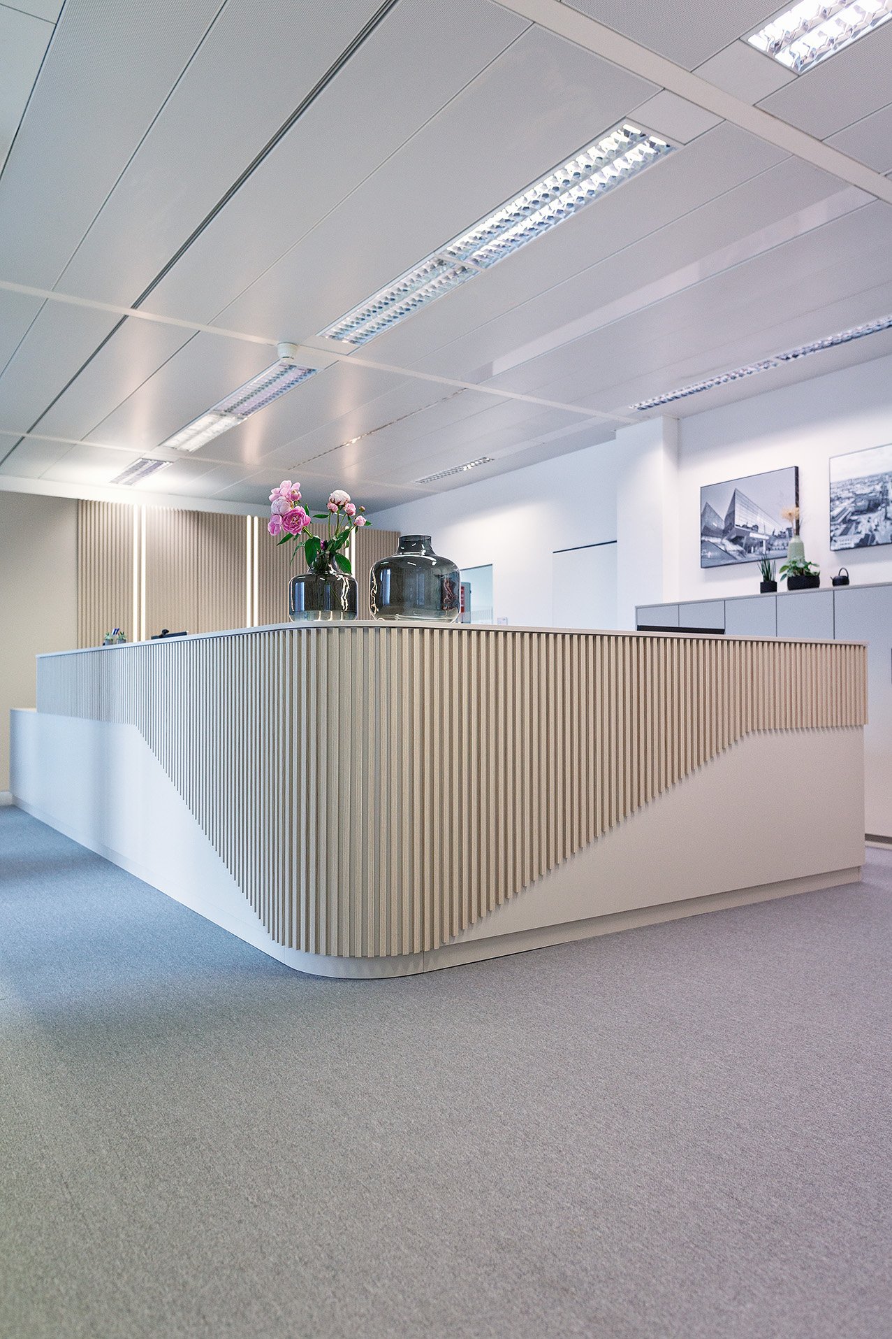Maßgefertigte Empfangstheke mit Holzlamellen im Büro – Innenarchitektur Viktoria Exler
